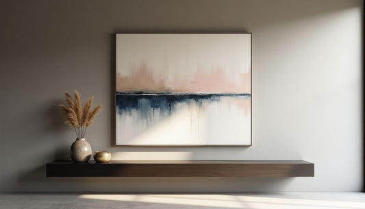 Minimalist interior: Grey Venetian plaster wall, abstract art, ebonized console, raku, dried grass.